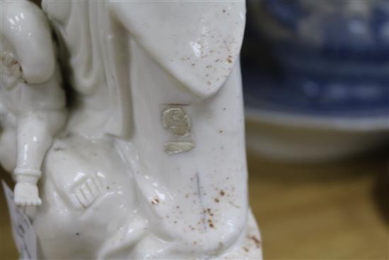 A large Chinese blanc de chine group of Guanyin and child, Kangxi period, damage and losses